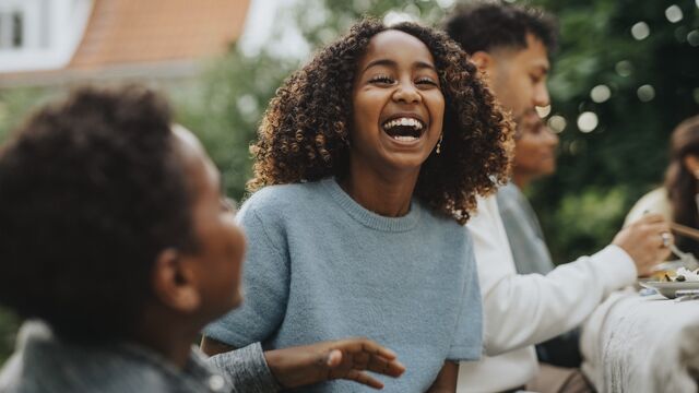 Girl smiling at family gathering - small